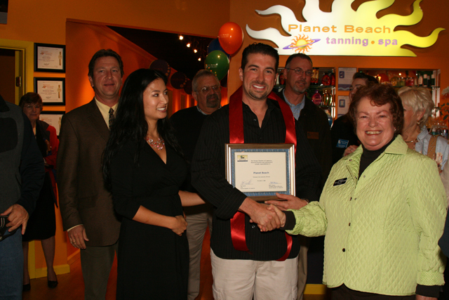 Ribbon cutting at a spa location during the franchise and operations era