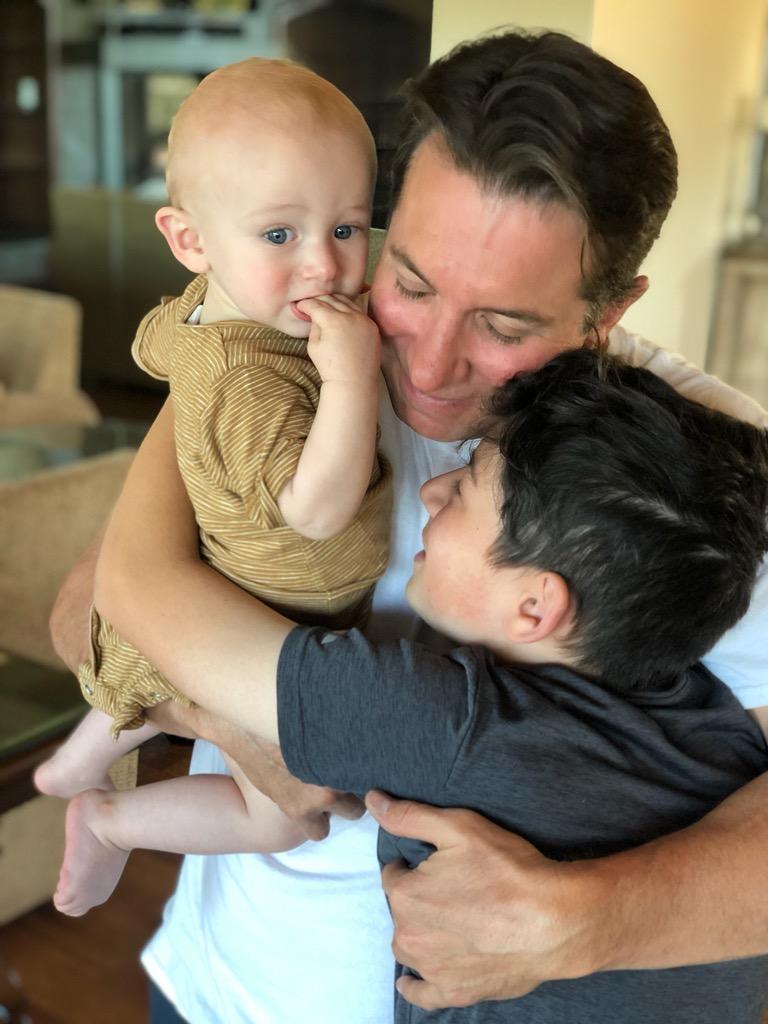 Brandon holding both of his sons