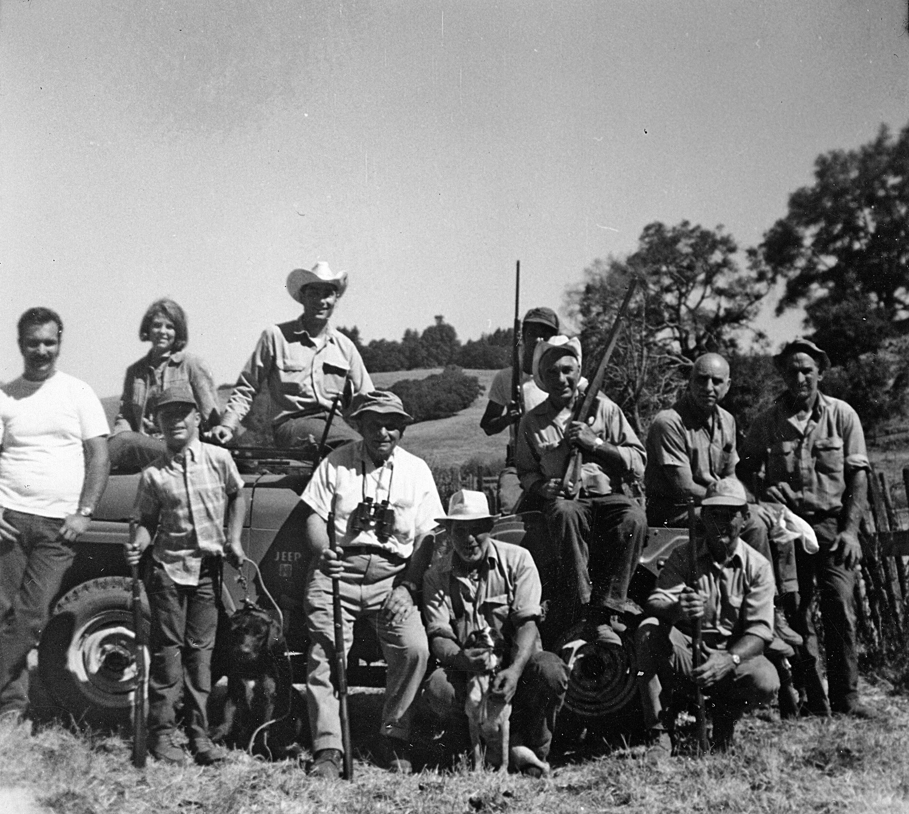 The hunting party gathered around the Jeep on the family ranch, West Sonoma County