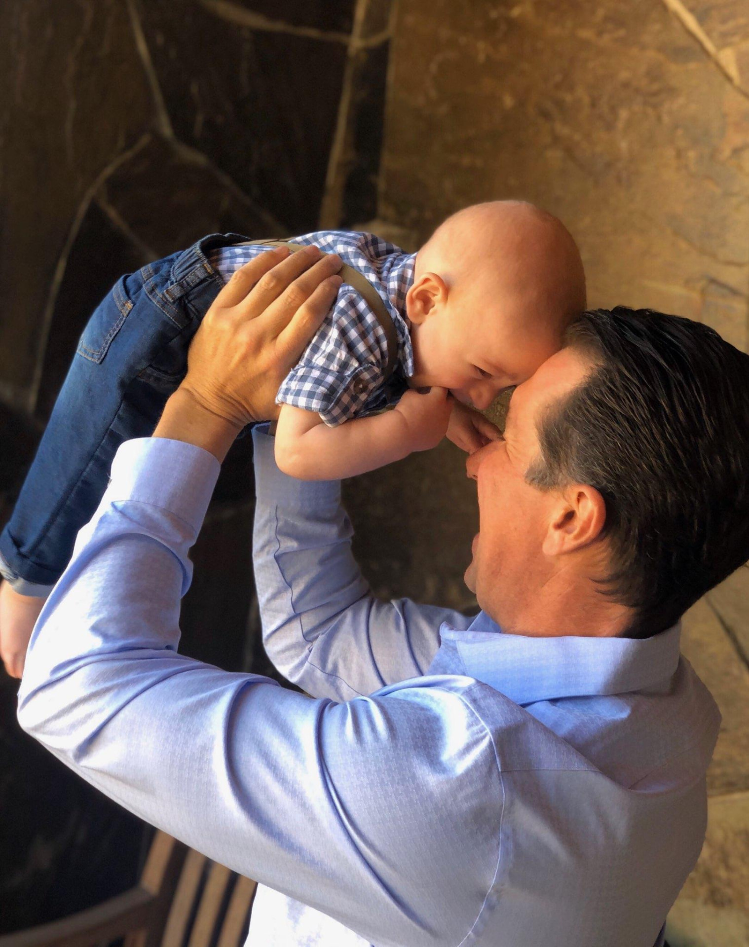 Lifting his infant son